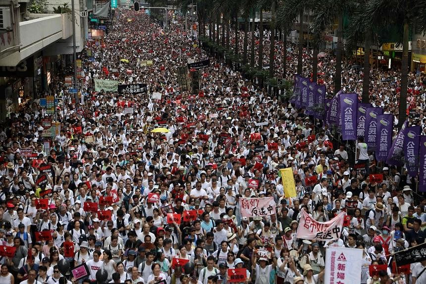 Protesters in Hong Kong yesterday marching during a rally against controversial proposed changes to an extradition law. Organisers have described the protest as the biggest seen in the territory since it was returned to the Chinese by the British in 