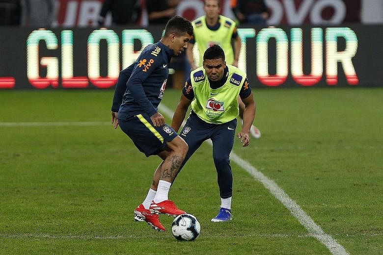 Brazil players Roberto Firmino (left) and Casemiro training at Beira-Rio Stadium in Porto Alegre on Saturday. The eight-time Copa America winners triumphed the last time they were hosts in 1989.