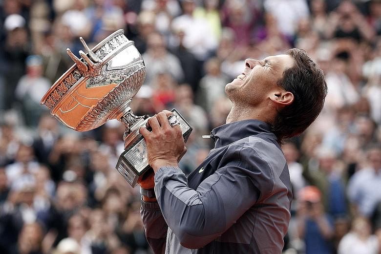 An emotional Rafael Nadal hoisting the Musketeers' Trophy for the 12th time on Sunday, after seeing off Dominic Thiem in the French Open final for the second year running. PHOTO: EPA-EFE