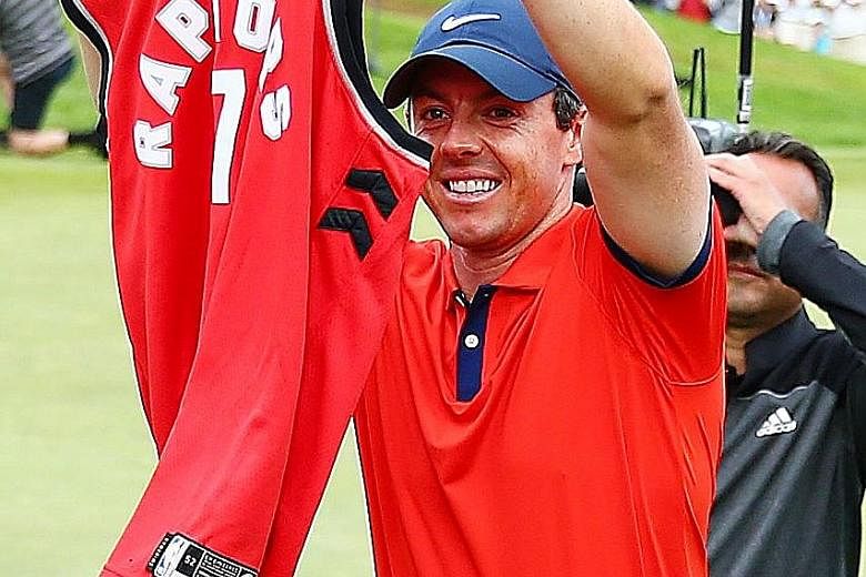Rory McIlroy with a Toronto Raptors jersey after winning the Canadian Open in Ontario on Sunday. The Raptors need one win to clinch their first NBA title.