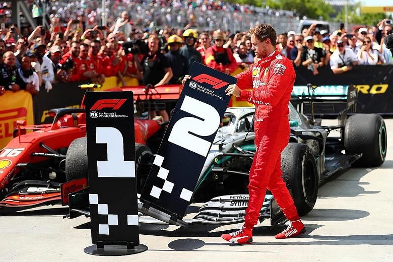 Ferrari's Sebastian Vettel taking it upon himself to swop the number boards for the finished cars at the parc ferme of the Circuit Gilles Villeneuve. The German crossed the finishing line at the Canadian Grand Prix first, but a time penalty meant he 