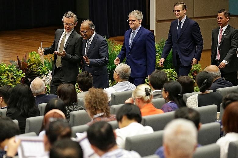 Minister for Home Affairs and Law K. Shanmugam, with dean of NUS Law Simon Chesterman (left) and director of the Asian Law Institute Gary F. Bell, arriving for the opening of the 16th Asian Law Institute Conference in NUS' Bukit Timah campus yesterda