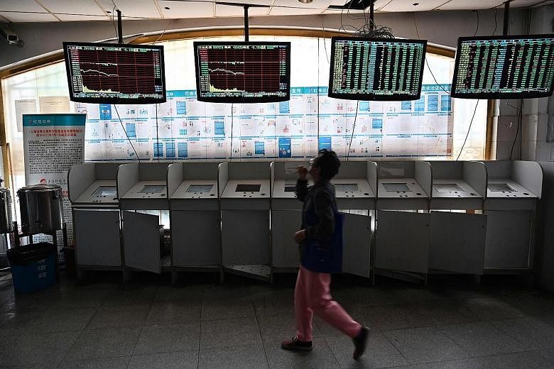 An investor checking stock price movements at a securities company in Shanghai. Chinese firms and investors are lining up to take part in Shanghai's new Nasdaq-style tech board, with a groundswell of patriotic support surging further after the US' bl