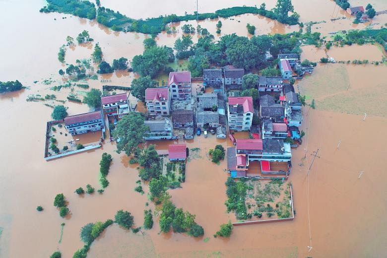 Homes submerged in floodwaters following heavy rainfall in Taihe county, Jiangxi province, on Monday. Thousands were stranded amid torrential rain across central and southern China, with floods wiping out 10,800ha of crops and destroying hundreds of 