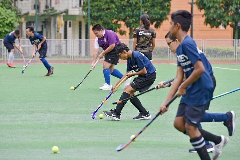 Boys from ACS (Barker Road) and Queensway during their twice-a-week training sessions at the Delta Hockey Pitch. Each school now has 18 hockey players.