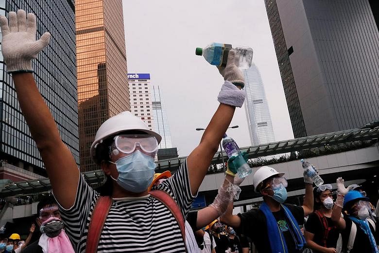 Protesters fleeing as police fired tear gas at a rally near the government headquarters. Some wore masks to protect themselves. Protesters threw water bottles, bricks and other items at riot police and chanted slogans, vowing to stay put until the Bi