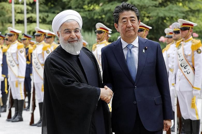 Iranian President Hassan Rouhani welcoming Japanese Prime Minister Shinzo Abe to Teheran yesterday. Mr Abe is the first Japanese leader to visit Iran since the 1979 Islamic Revolution. He will hold talks with Mr Rouhani and meet the Islamic Republic'