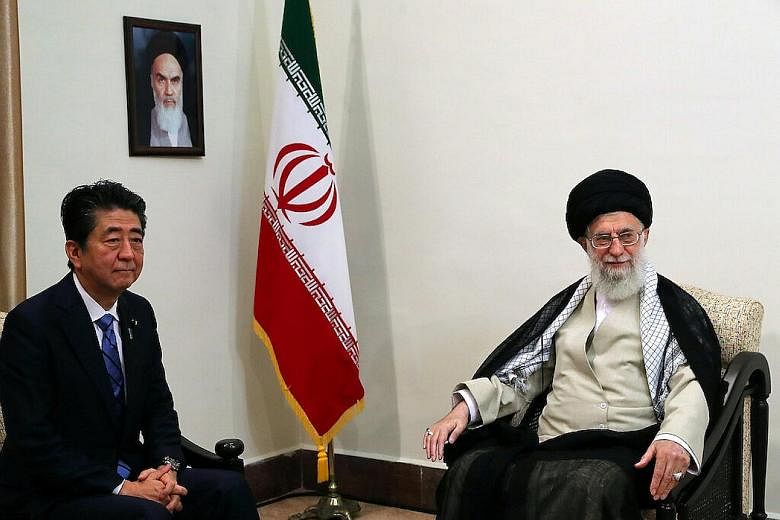 Japanese Prime Minister Shinzo Abe meeting Iran's Supreme Leader Ali Khamenei in Teheran yesterday. Mr Abe later told reporters Mr Khamenei had promised Iran had no intention of pursuing nuclear weapons. PHOTO: REUTERS