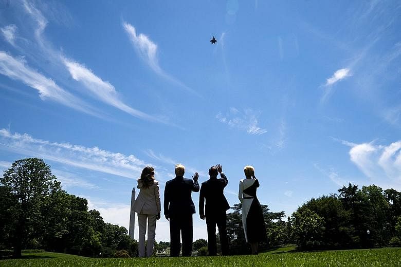 From left: Mrs Melania Trump and President Donald Trump, with President Andrzej Duda of Poland and his wife Agata Kornhauser, watching an F-35 fighter jet flying over the White House grounds on Wednesday. Poland has committed to buying about 30 F-35 