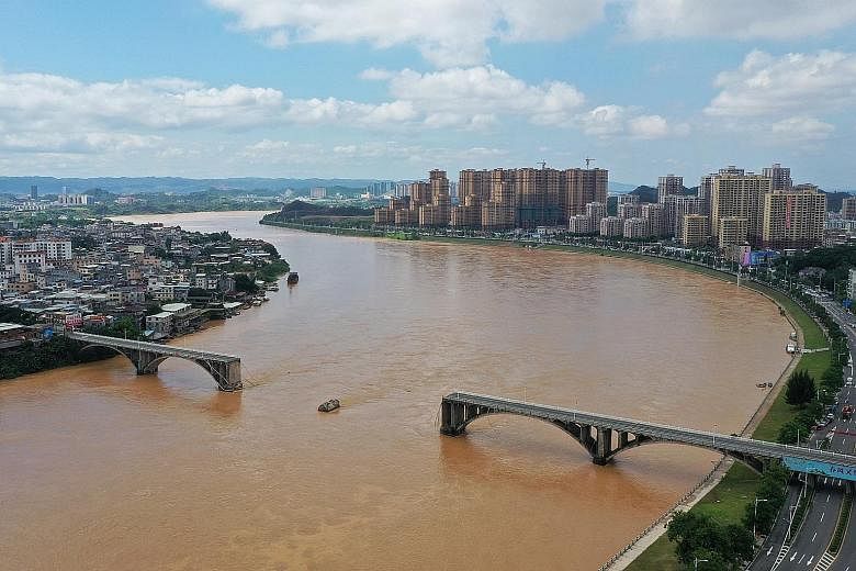 In Guangdong province, at least two vehicles plunged into the Dongjiang River after part of a bridge collapsed in the urban area of Heyuan city early yesterday, according to the local authorities. A herd of cattle stranded by floodwaters on Wednesday