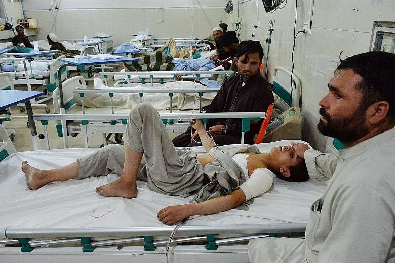 An Afghan victim receiving medical treatment in hospital after a suicide bomb attack in Jalalabad on Thursday. There was at least one child among the fatalities, while three other minors were wounded.