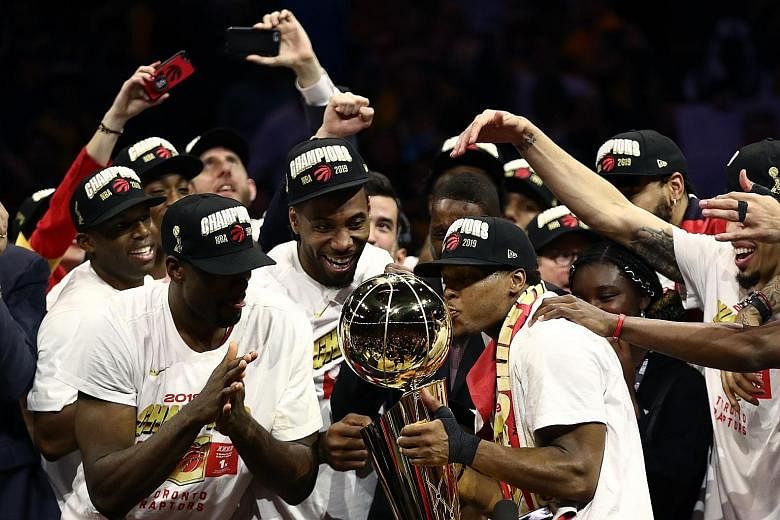 The Toronto Raptors celebrate with the Larry O'Brien Championship Trophy after defeating two-time defending champions Golden State Warriors 114-110 in Game Six for a 4-2 victory in the NBA Finals. 