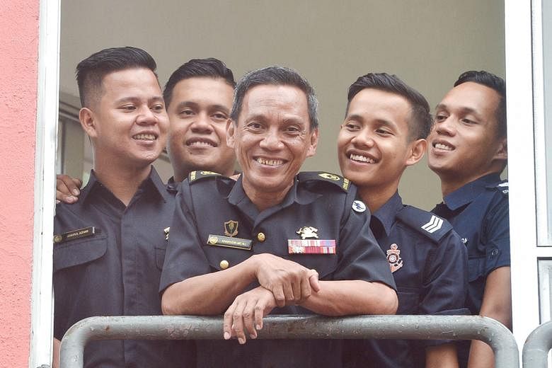 Senior Warrant Officer 1 Khairudin Mohamed Ali with his sons (from left) Khairul Azhar Khairudin, Khairul Anwar Khairudin, Khairul Ariffin Khairudin (in his Police Coast Guard uniform for in-camp training) and Muhammad Khairi Khairudin at Woodlands F