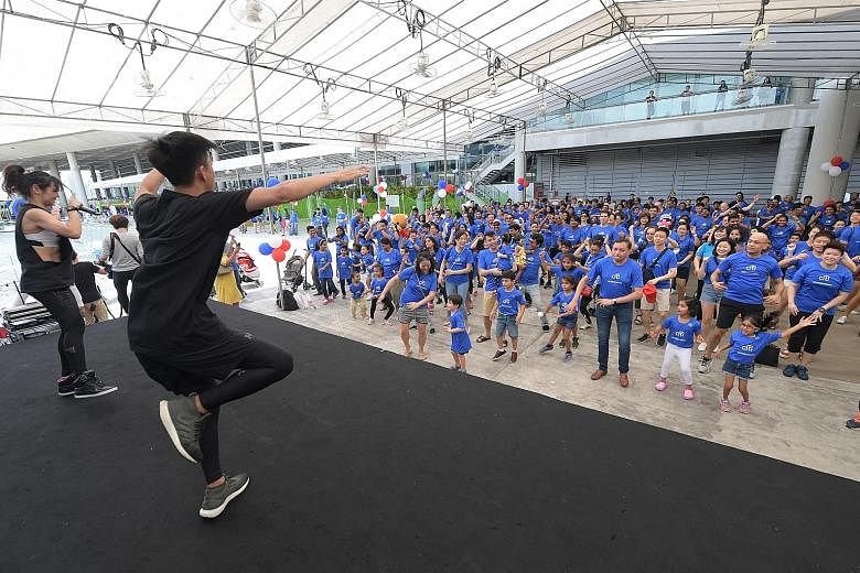 More than 200 Citi Singapore employees took part in a mass "Silent Zumba" yesterday as part of the bank's global community day. It was one of several activities held by the bank at the Marina Barrage. The others included a social bazaar, a carnival a