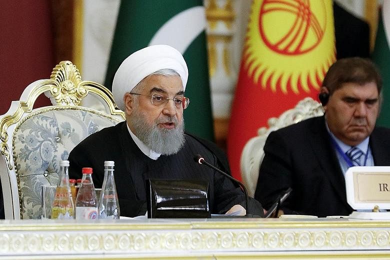 Iranian President Hassan Rouhani (left) said his country cannot unilaterally stick to the 2015 nuclear deal while speaking at the Conference on Interaction and Confidence Building Measures in Asia in Dushanbe yesterday.