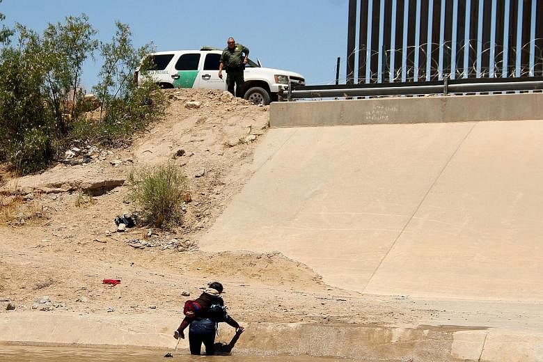 Two Central American migrants crossing the Rio Grande in Mexico last week, before turning themselves in to United States Border Patrol agents to claim asylum. Angry over a surge of Central Americans seeking US asylum, President Donald Trump is pushin