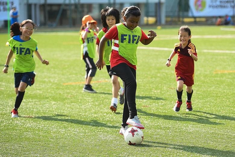 Young girls enjoying a game during the Football Association of Singapore Women's Football Day at Bowen Secondary School in March. More girls are taking up the sport but more support, in terms of training, finances and publicity, is needed. 