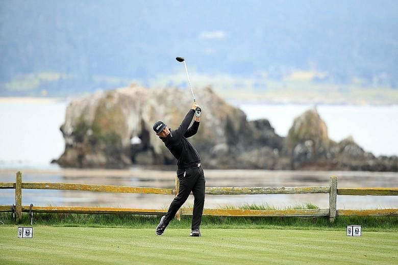 American Gary Woodland teeing off at the 18th hole during the second round of the US Open at Pebble Beach on Friday. He shot a record-equalling six-under 65 for a nine-under 133 total to take a two-shot lead into the third round.