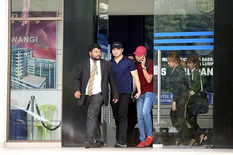 Mr Haziq Aziz (centre), principal private secretary to Deputy Minister for Primary Industries Shamsul Iskandar Akin, was released on police bail yesterday evening. He had been arrested just as he was about to leave for Manila on Friday evening and wa