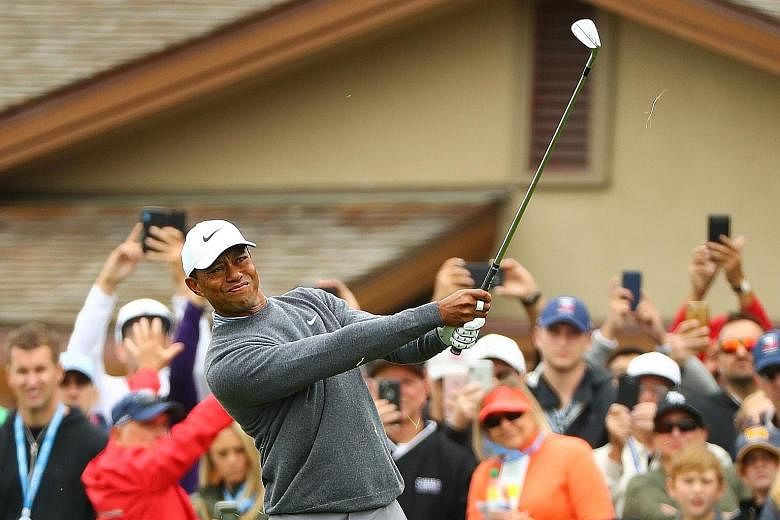 Tiger Woods playing a shot on the first hole in the third round of the US Open on Saturday at Pebble Beach Golf Links. He made bogey - one of five that day. But he mixed it up with five birdies to stand at even-par 213. PHOTO: REUTERS