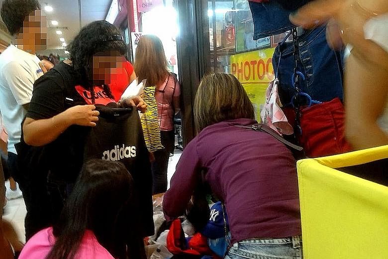 Counterfeit apparel of famous brands such as Adidas, Under Armour and Levi's being sold outside a fourth-storey shop at Lucky Plaza. Those found guilty of distributing goods with falsely applied trademarks for the purpose of trade can be jailed up to
