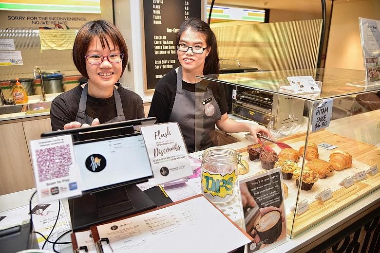 Ms Carmen Tan (left), 23, and Ms Rachael Lum, 19, are among the employees with special needs who work at Foreword Coffee. The employees are assigned to one station at any one time so that they learn a specific process instead of all at one go. Specif
