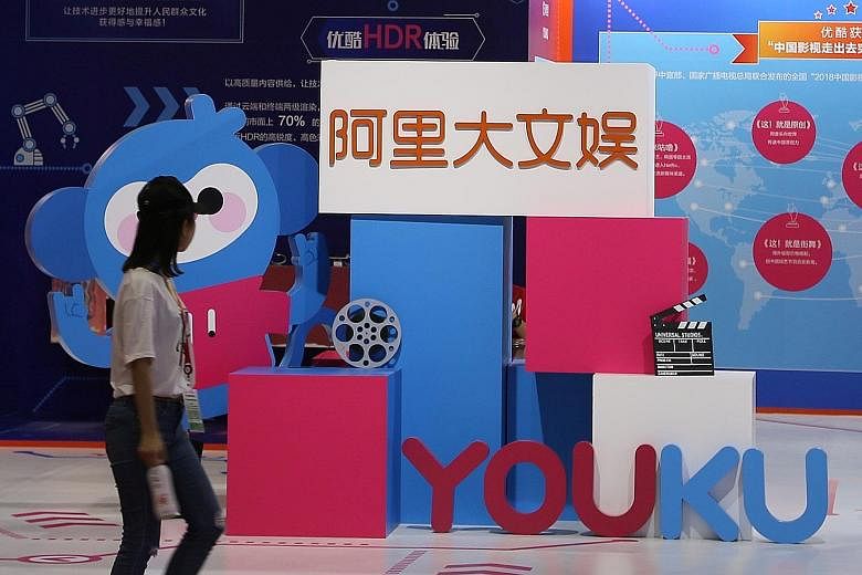 Signs for Alibaba Culture and Entertainment Group and Alibaba's video-streaming unit Youku. Alibaba is looking to invest in new business lines such as cloud computing, as a boom in its core e-commerce has peaked and revenue growth slows. PHOTO: REUTE