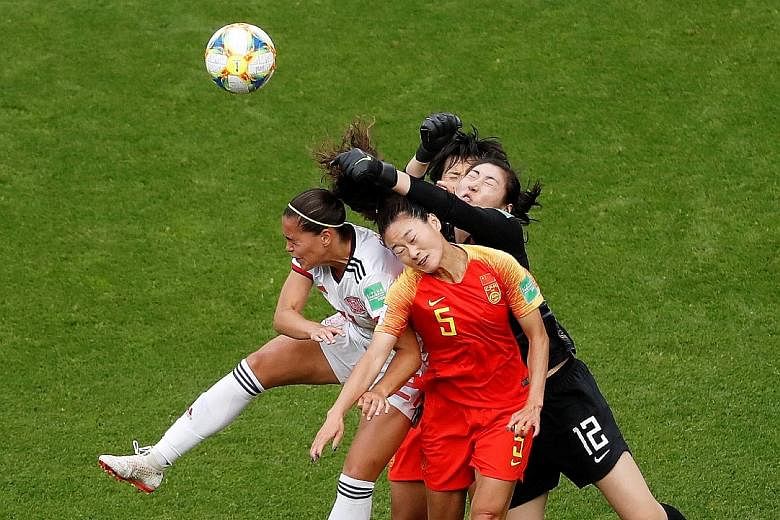 China defender Wu Haiyan and goalkeeper Peng Shimeng trying to block out the threat of Spain forward Andrea Falcon during the 0-0 World Cup draw on Monday. Both teams are through to the knockout stage of the competition despite the stalemate.