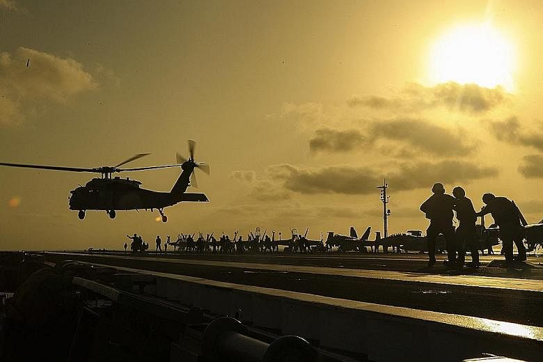 A helicopter lifting off from aircraft carrier USS Abraham Lincoln in the Arabian Sea. The US' defence chief this week announced the deployment of about 1,000 more troops to the Middle East for defensive purposes. PHOTO: EPA-EFE