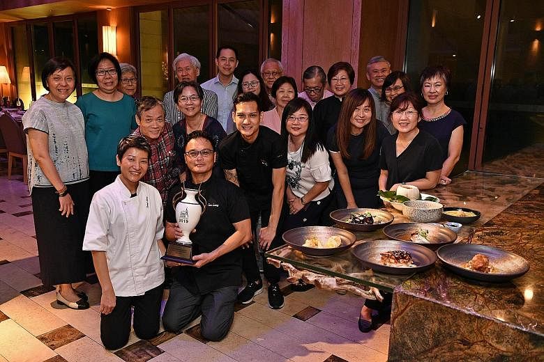 Celebrity chef Sam Leong (kneeling with his wife Forest and son Joe, on the right) with Straits Times subscribers who won a six-course dinner to his restaurant, Forest, as part of the ST+ news with benefits programme.