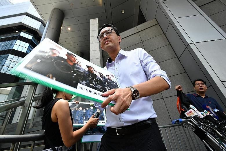 Hong Kong Democratic Party legislator Lam Cheuk-ting holding a press conference outside the Police Headquarters in Hong Kong yesterday.