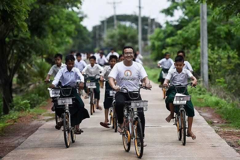 Myanmar children on bicycles - donated under the Lesswalk scheme that aims to give them easier access to education - in the compound of a Buddhist monastery on the outskirts of Yangon on Tuesday. The bicycles were previously used by bike-sharing comp