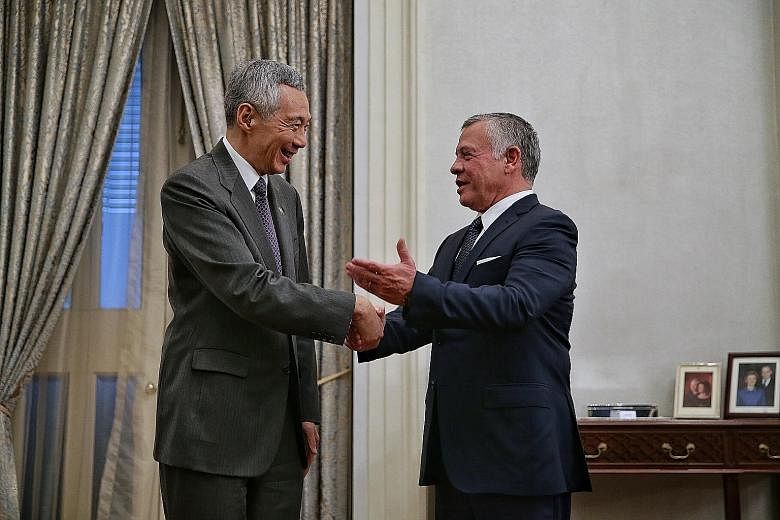 Above: Prime Minister Lee Hsien Loong meeting King Abdullah at the Istana. They reaffirmed the strong bilateral cooperation in many areas. ST PHOTO: KEVIN LIM Below: Nanyang Technological University president Subra Suresh (right) giving King Abdullah