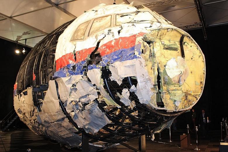 The reconstructed front part of the Malaysia Airlines plane at the Gilze-Rijen Air Force Base, in the Netherlands, in 2015. Parts of the cockpit and business class section were reconstructed from wreckage retrieved from Ukraine and taken to the Nethe