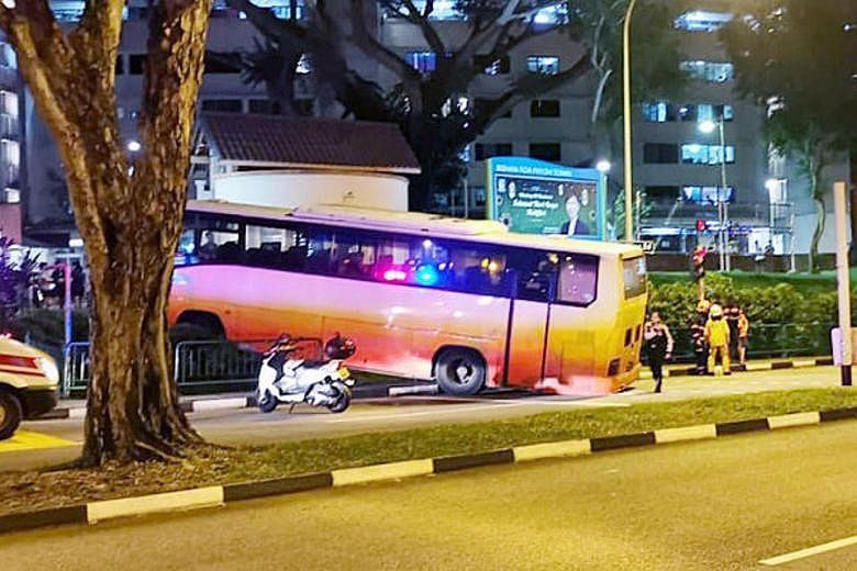 An eyewitness said the bus ran a red light before colliding with a car (left). It stopped only after it went through the barrier on the pedestrian walkway (above).