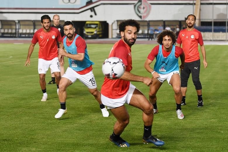 Egypt's star forward Mohamed Salah on the ball during training last Sunday at the Cairo Military Academy Stadium, with teammates including defender Abdullah al-Saeed (second from left) and midfielder Amr Warda (second from right). The hosts play Zimb