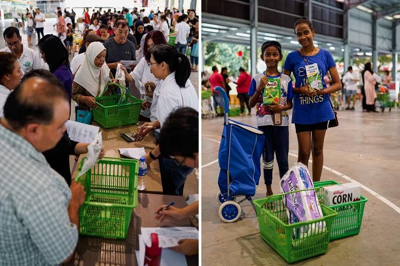 Siblings Jayben and Sabrina Louis (both above) with items from a pop-up supermarket in Yishun. They were among the beneficiaries from low-income households given vouchers to shop at two pop-up supermarkets for what they needed or wanted (left). ST PH