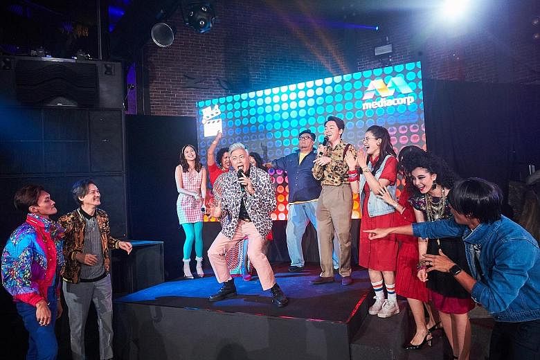 Singapore singer Dick Lee (centre stage) performing his song, Fried Rice Paradise, with the cast of the drama series of the same name at Zouk nightclub on Thursday.