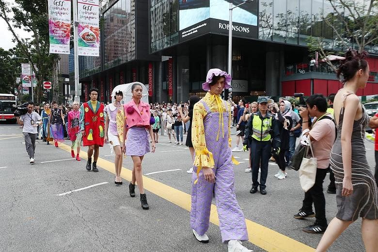 In nine 50-second sequences timed between traffic lights, 100 models showed off designs from both local and international designers at the intersection between The Heeren, Mandarin Gallery and retail store Design Orchard yesterday.