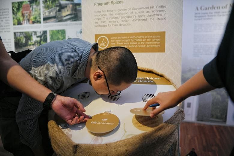 A visitor takes a whiff of spices at an interactive segment at the exhibition, which also explores what people want for the future.