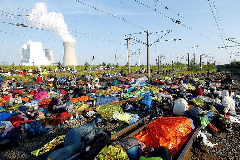 Green activists in Germany blocking railway tracks near a coal mine during a protest for action against climate change yesterday.