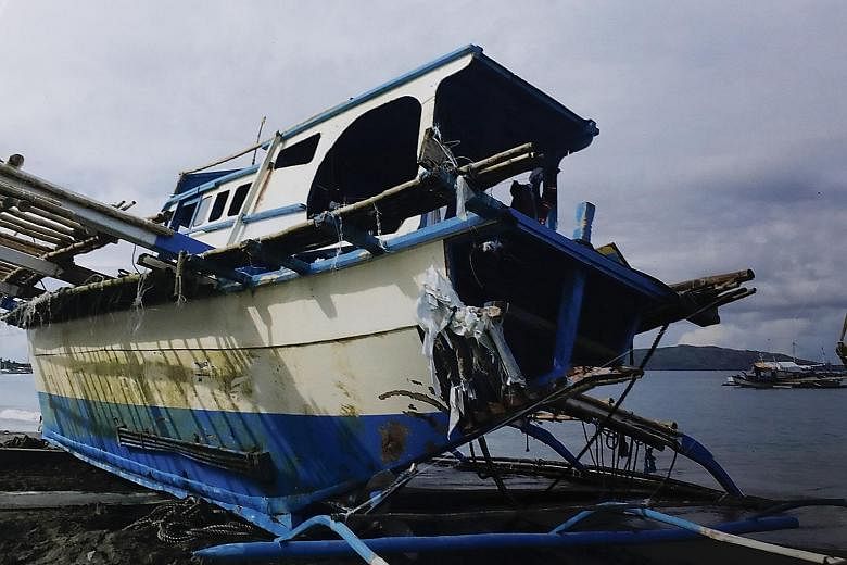 The damaged fishing boat Gem-Vir on the shore of San Jose town in the Philippines. PHOTO: EPA-EFE