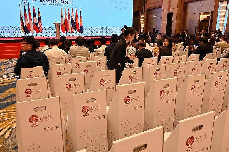Journalists sitting on chairs made out of paper before a news conference at the 34th Asean Summit yesterday. On Saturday, Asean had committed itself to reducing marine waste at both the national and regional levels. Yesterday, it laid out its Asean O