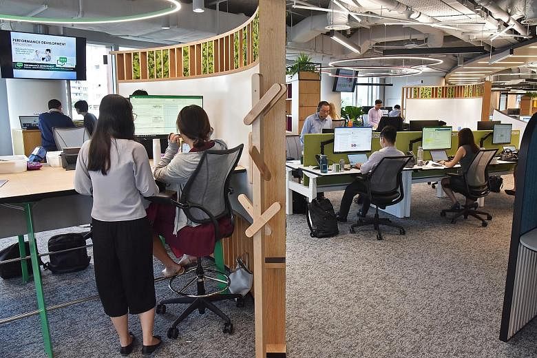Real estate agency CBRE's new headquarters at Paya Lebar Quarter has various working spaces, such as (clockwise from above) the cafe and working area, a room which houses a state-of-the-art presentation tool called the Liquid Galaxy, and the team tot