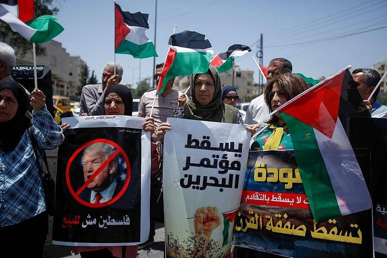 Demonstrators with banners, including one that reads "Palestine is not for sale" in Arabic, protesting in Bethlehem. Arab analysts believe the economic plan being put forward by the US is an attempt to buy off opposition to Israel's occupation of Pal