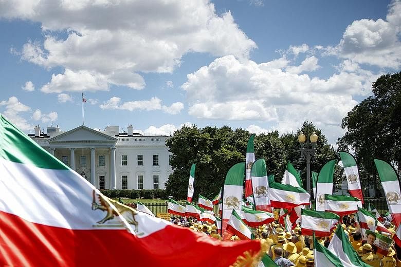 Protesters in Washington holding flags of Iran prior to the Islamic Revolution in front of the White House on Friday, while calling for a regime change within the Iranian government.