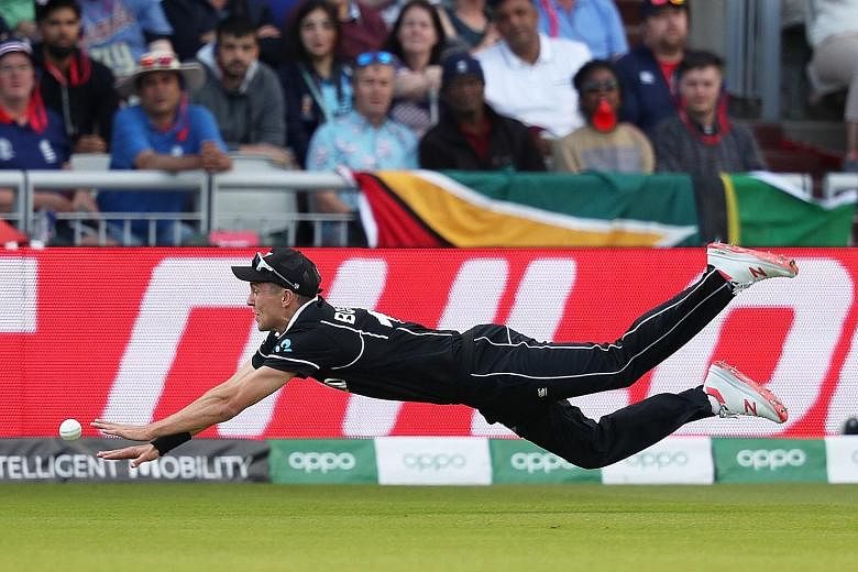 New Zealand's Trent Boult diving to attempt a catch in Saturday's Cricket World Cup match against West Indies. Boult said fans back home would enjoy "diving into their poached eggs" after the Kiwis snatched victory when West Indies had seemed headed 