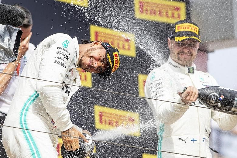 Britain's Lewis Hamilton (left) having a splashing time with his second-placed Mercedes teammate Valtteri Bottas, over whom his lead is now 36 points while Ferrari's Sebastian Vettel is a further 40 points back. 