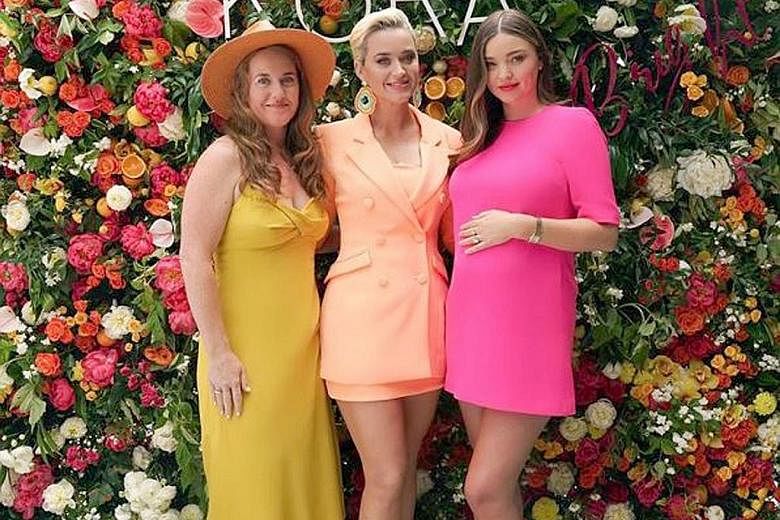 Singer Katy Perry (centre) and her sister Angela Hudson (left) at the launch of the new skincare line by model Miranda Kerr (right).