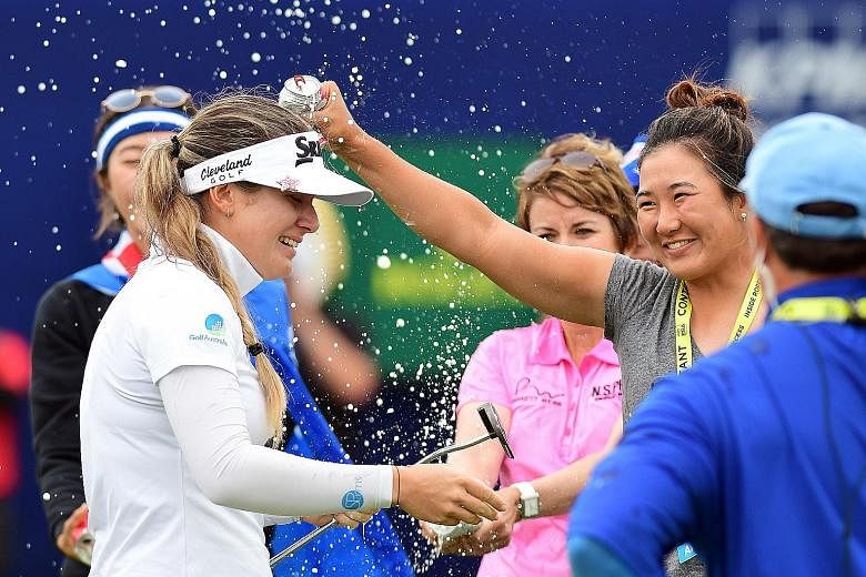 Hannah Green is drenched after the Australian edged out South Korean Park Sung-hyun by one stroke to win the Women's PGA Championship at Hazeltine National Golf Club on Sunday.